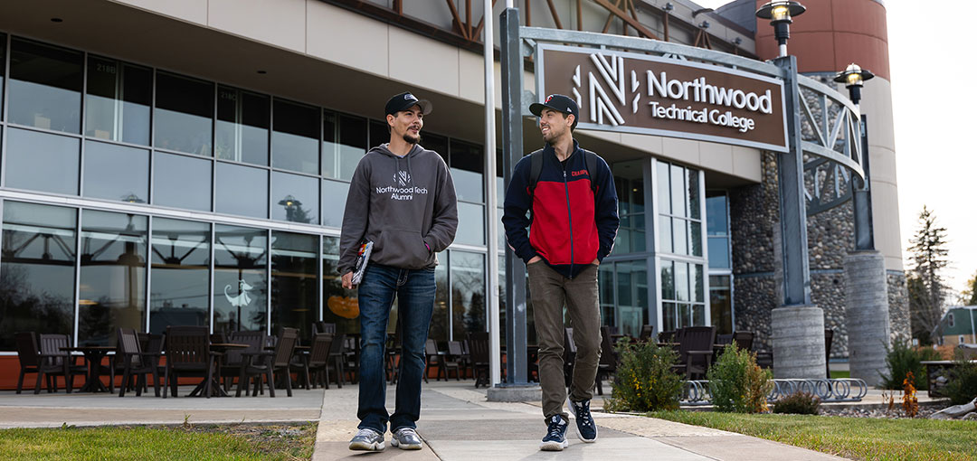 Students walking outside campus on a fall day
