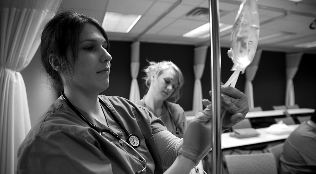A nursing student practicing skills used in the industry