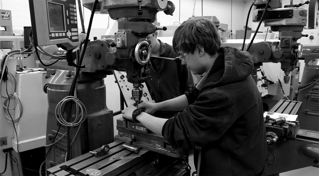 A student working on machinery