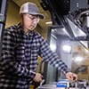 A machine tool student performing hands-on work