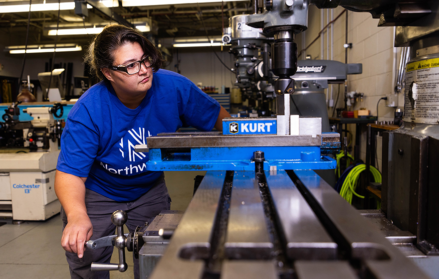 Student working on machining equipment 