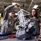 A student working on an engine in the power sports lab