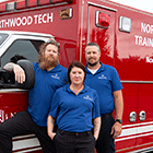 3 Advanced EMT students standing in front of Northwood Tech ambulance