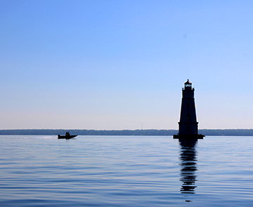 Silhouette of lighthouse and boat on Lake Superior