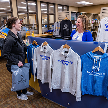 Student purchasing Northwood Tech gear in the bookstore