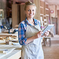 Woman using a tablet in her business workshop