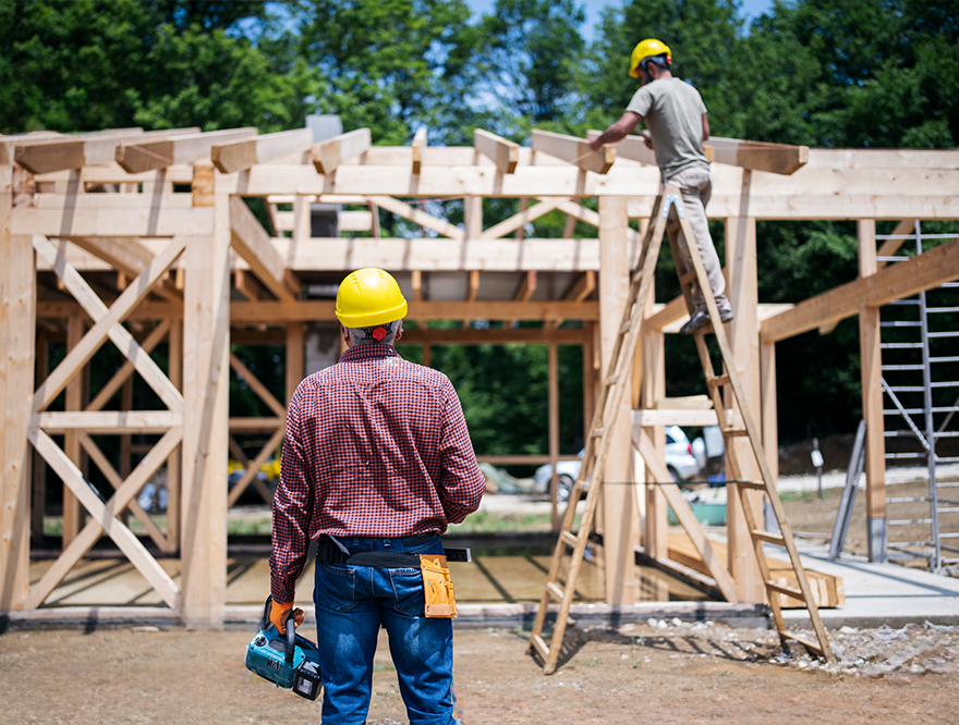 A construction worker working on the framing of a house