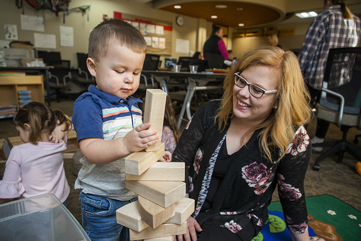 Early Childhood Education student and a child playing with blocks