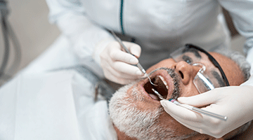 Patient with open mouth during dental procedure