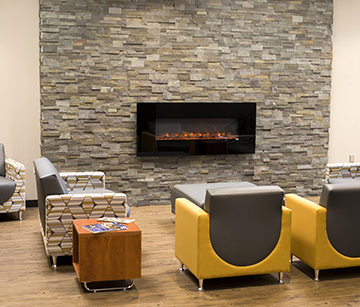 A fireplace and chairs at the New Richmond campus