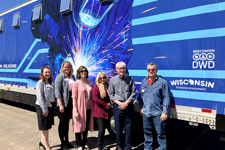 Northwood Tech employees in front of mobile welding lab with Governor Evers