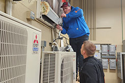 Students troubleshooting HVAC system