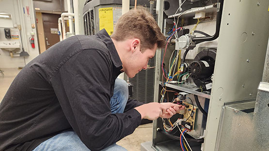 Student doing hands-on work in the HVAC industry