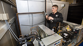 An HVACR student doing hands-on work