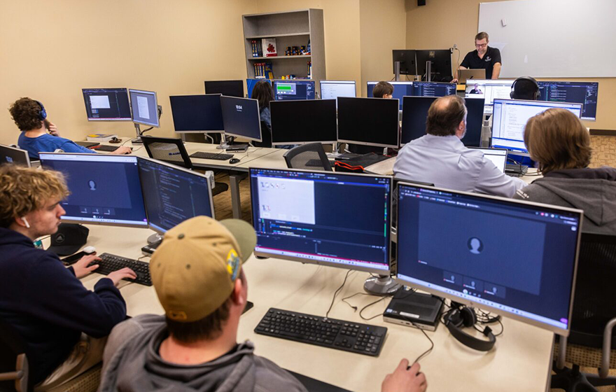 Students in the computer lab listening to instructor