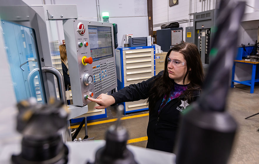 A female student doing hands-on work in the Automation for Industrial Systems program