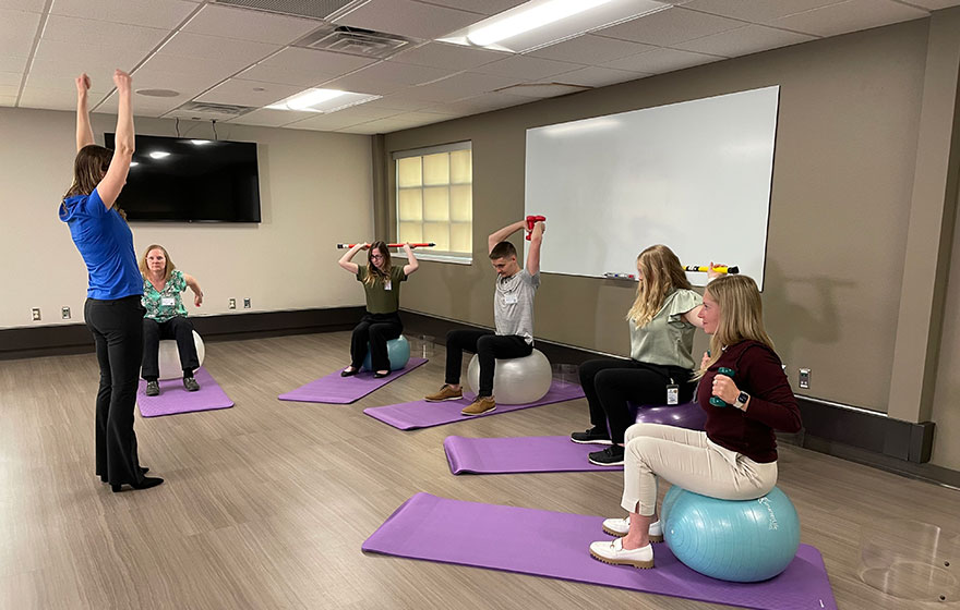 Instructor and students exercising in Occupational Therapy classroom