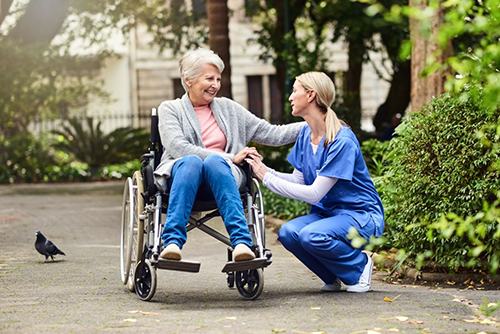 A medical professional assisting a resident in a wheelchair