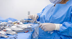 surgical technologist is organizing the medical instruments at an operating room