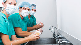 Surgical team washes hand prior to surgery