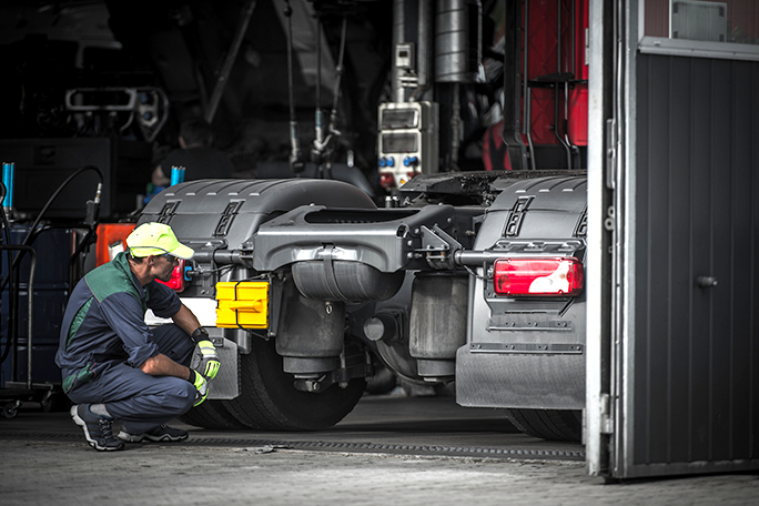 A diesel technician analyzing a semi truck