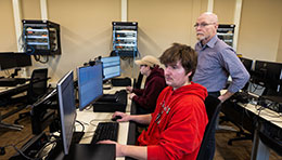 Northwood Tech instructor assisting students on computer