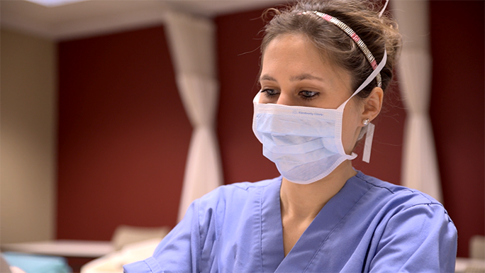 A nursing student wearing a surgical face mask 