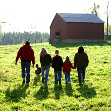 Family walking through farm land