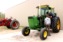 Two students working on a tractor