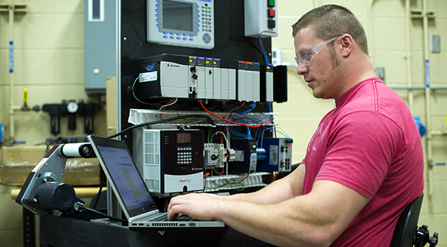 A student working on a computer in the industrial systems lab